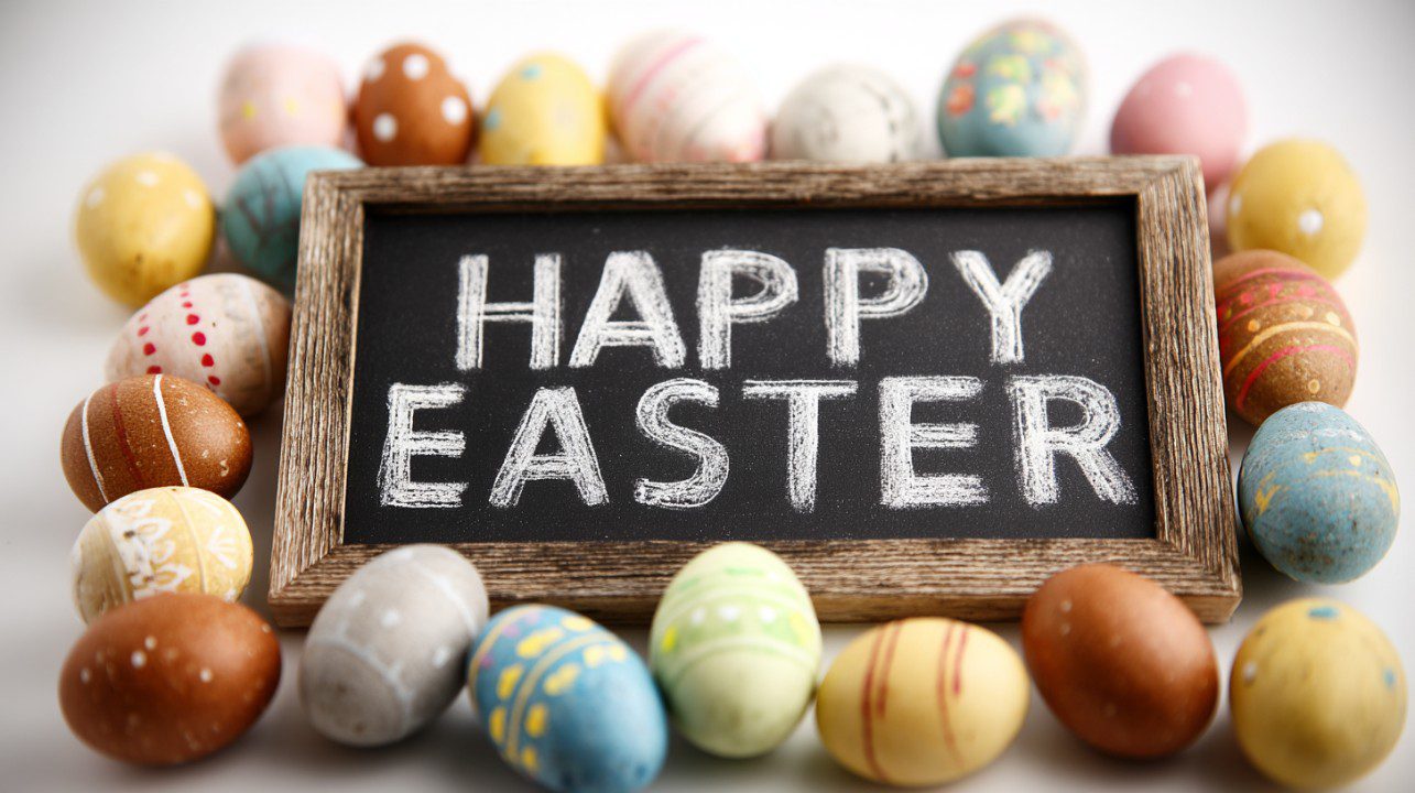 A rustic chalkboard sign reading "Happy Easter" surrounded by colorful painted eggs on a clean white background.