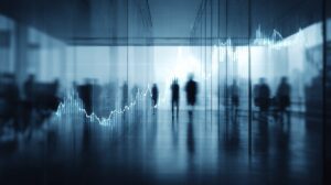 Blurred silhouettes in a modern office with an abstract rising stock market chart overlay.
