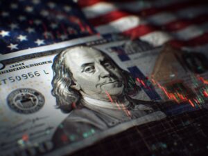 Close-up of US dollar bill with American flag background and stock market chart overlay representing financial markets.