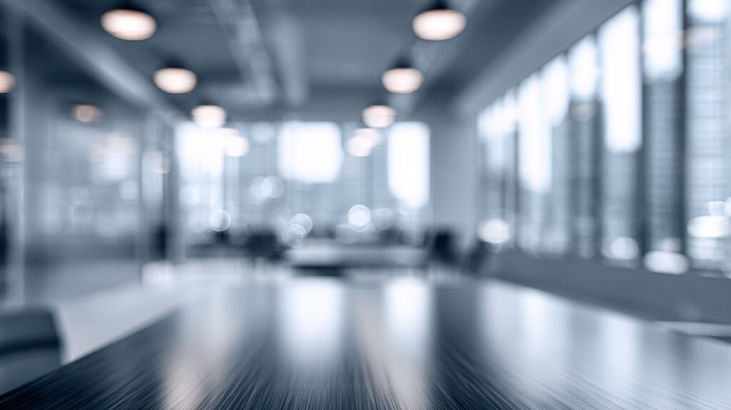 A blurred view of a modern corporate office in cool grey and blue tones, ideal for professional presentations or backgrounds.