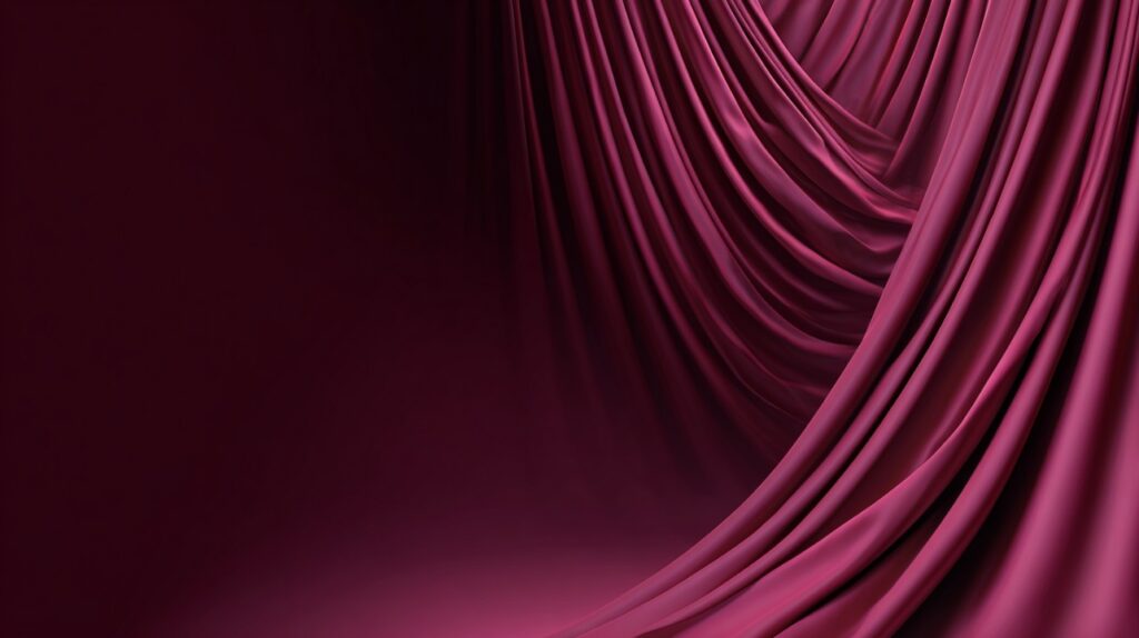 Luxurious burgundy curtain with flowing drapes and deep maroon tones, perfect for stage or elegant visual designs.