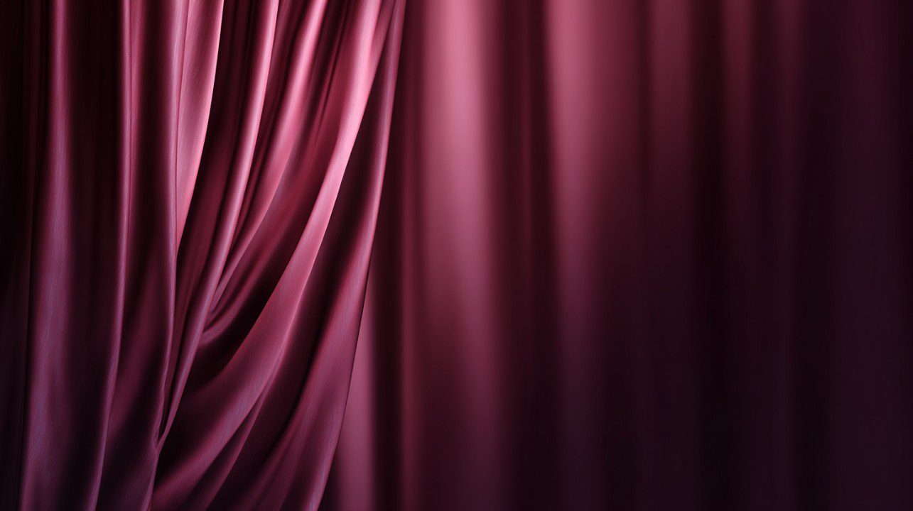 Elegant burgundy curtains with soft folds and smooth maroon lighting, suitable for stage or luxury design backgrounds.