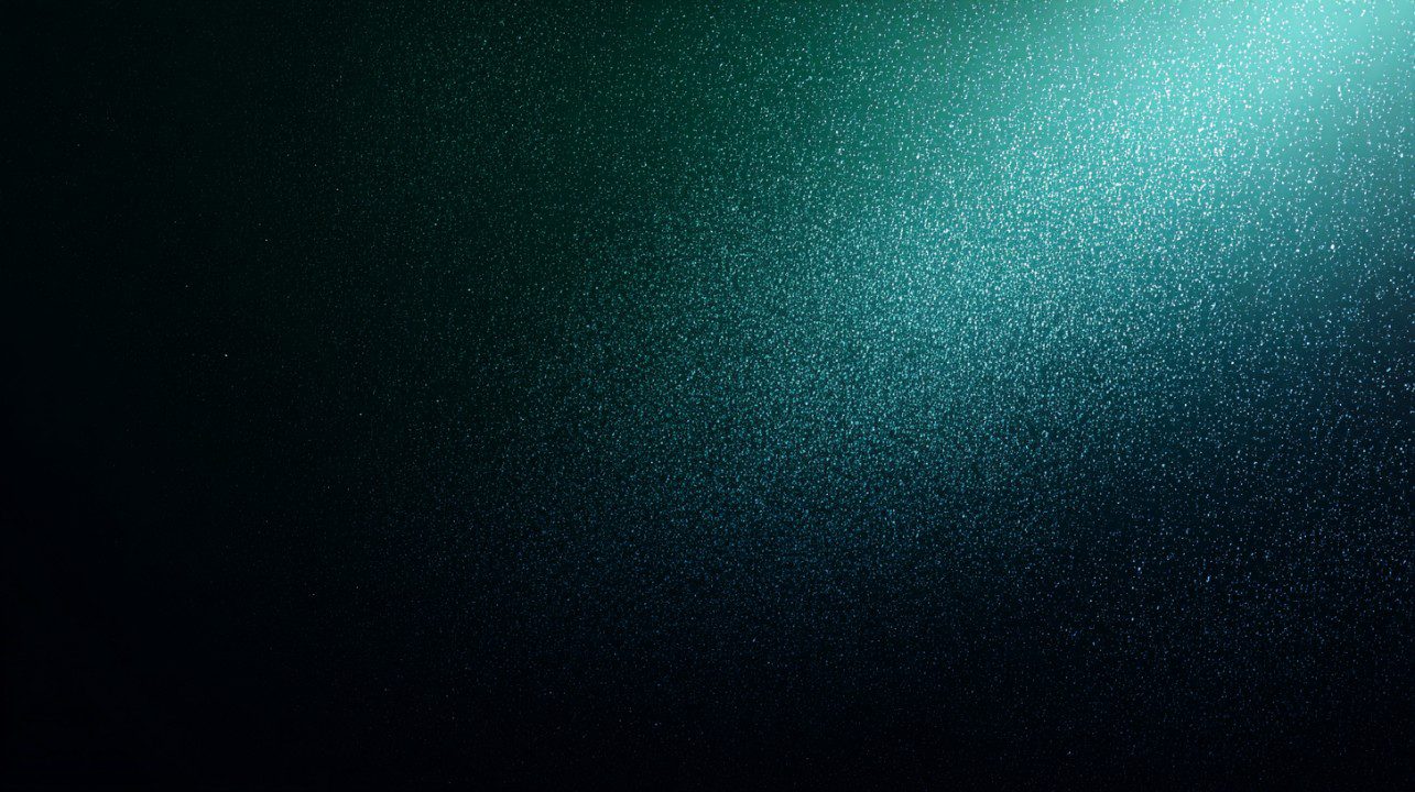 A widescreen dark green gradient background with a smooth texture and fine glitter-like particles for sleek modern design use.