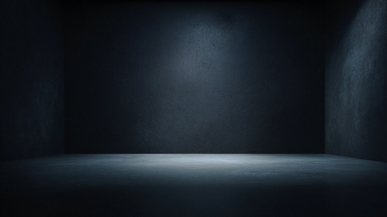 Dark photo studio background with soft ambient lighting creating a moody and minimalist atmosphere.