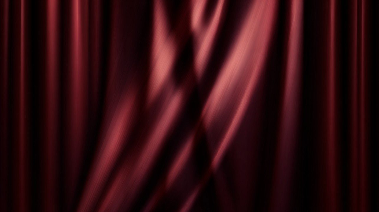 Deep burgundy curtain with soft lighting and dramatic folds, suitable for elegant stage or branding visuals.