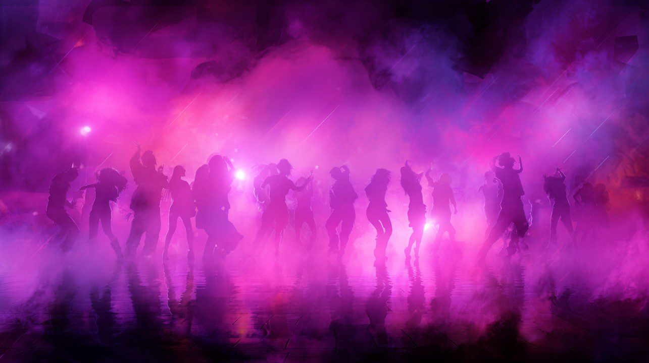 Silhouettes of dancers at an urban dance party surrounded by vibrant pink and purple fog lights creating an energetic atmosphere.