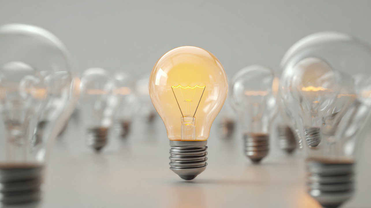 Standout Idea – Glowing Light Bulb Among Many - PresentationGO