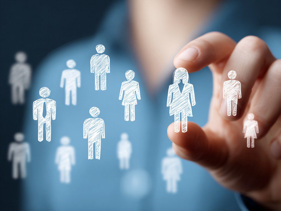 Hand selecting a drawn human icon representing recruitment and HR processes.