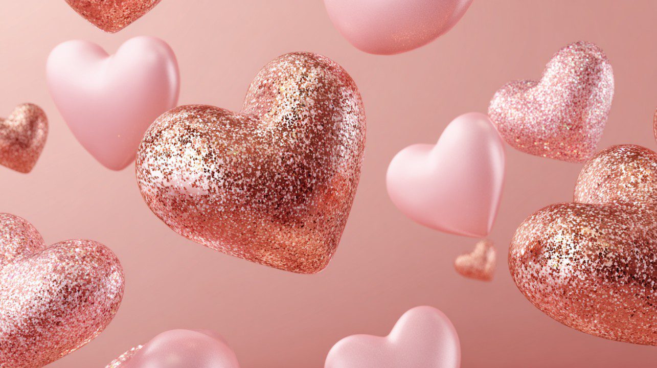 Floating rose gold and pink glitter hearts on a pastel background, symbolizing love, romance, and Valentine’s Day celebration.