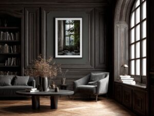 Sophisticated living room with dark wood paneling, grey modern chairs, and a large framed botanical artwork on the wall, lit by tall arched windows.