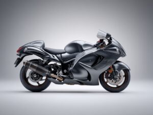 Black sport motorcycle isolated on a clean gray background, highlighting sleek design and high-performance styling.
